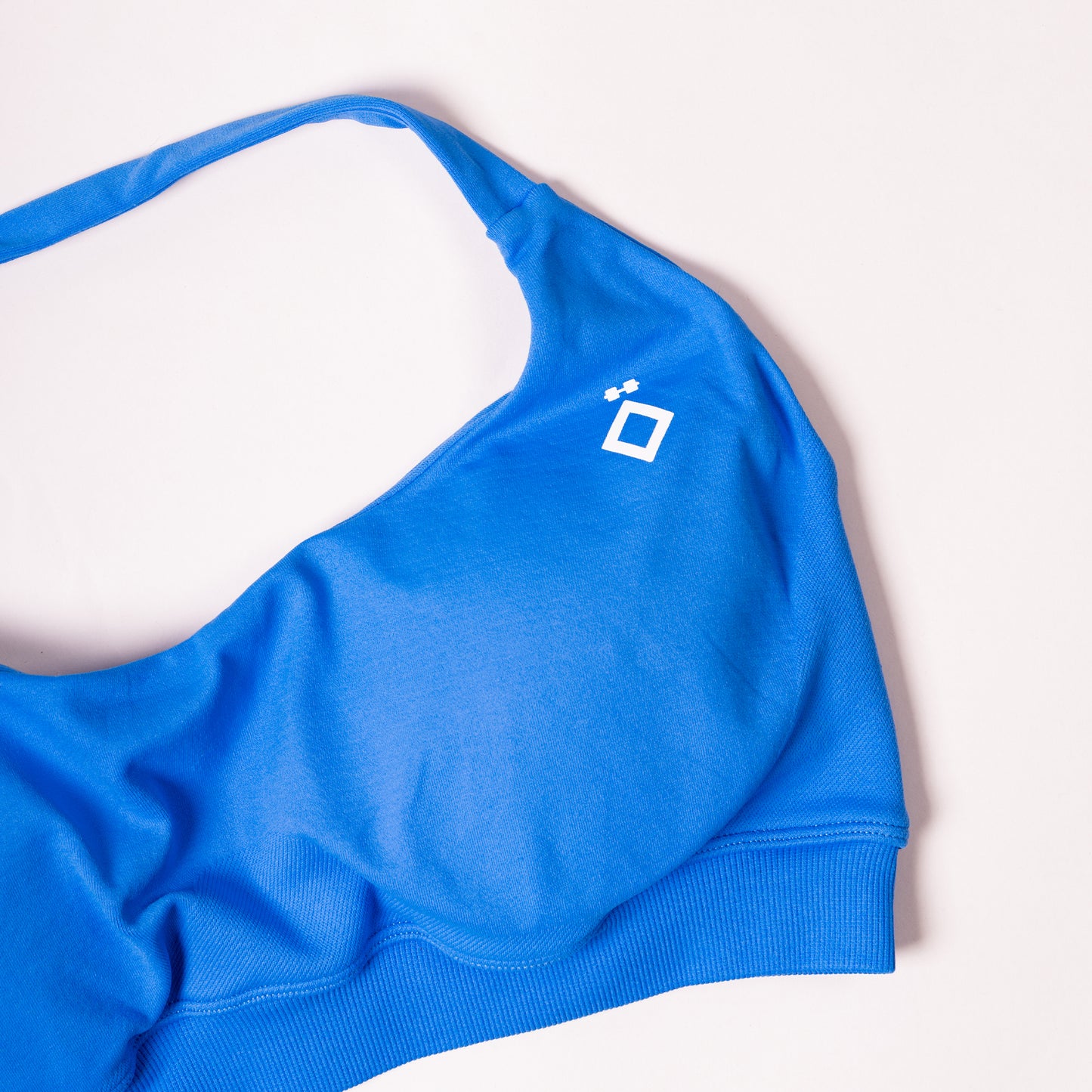 Blue sports bra with a logo on a white background
