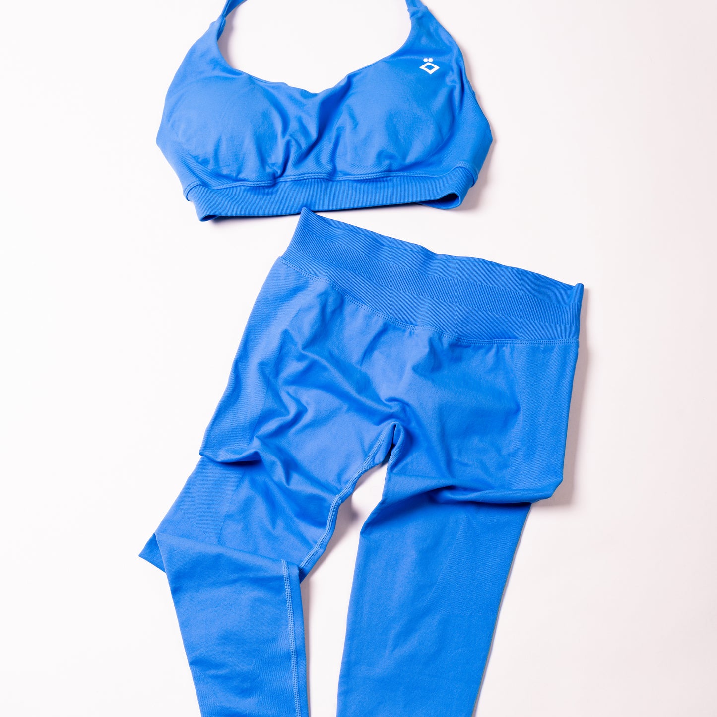 Blue sports bra and leggings set on a white background