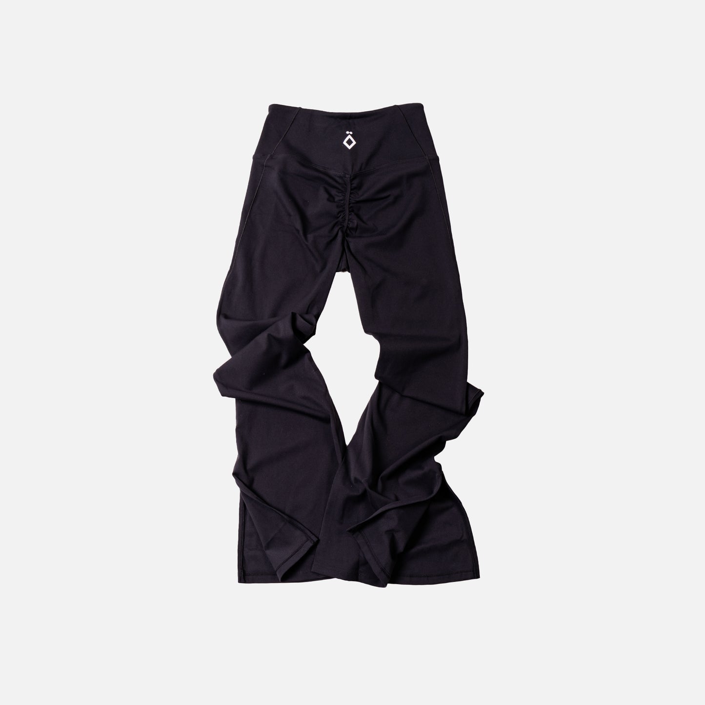 Black leggings flare with ruched design on a light gray background