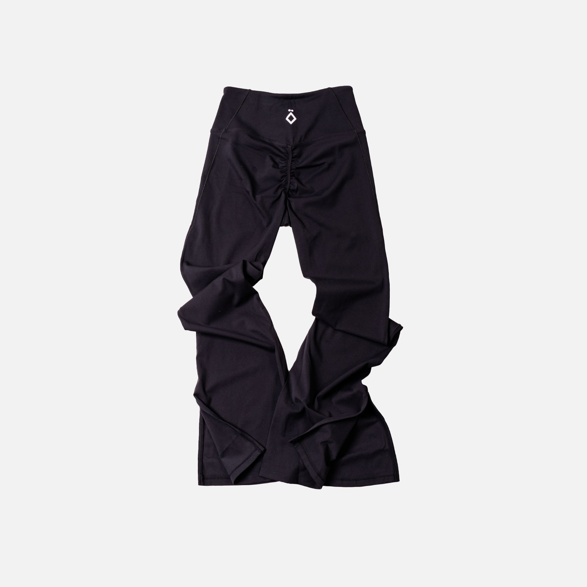 Black leggings flare with ruched design on a light gray background