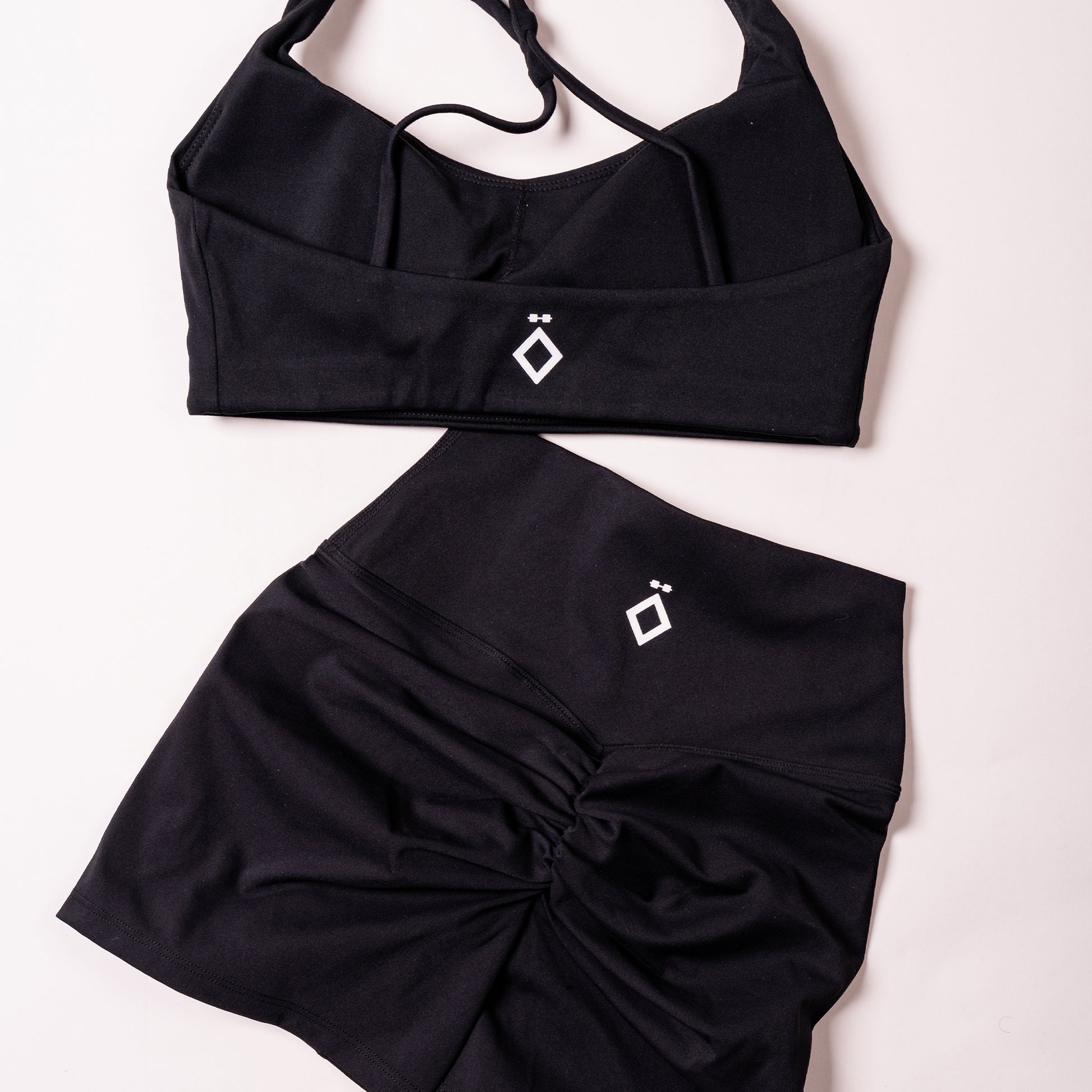 Black activewear set with cross-back sports bra and ruched sculpt shorts