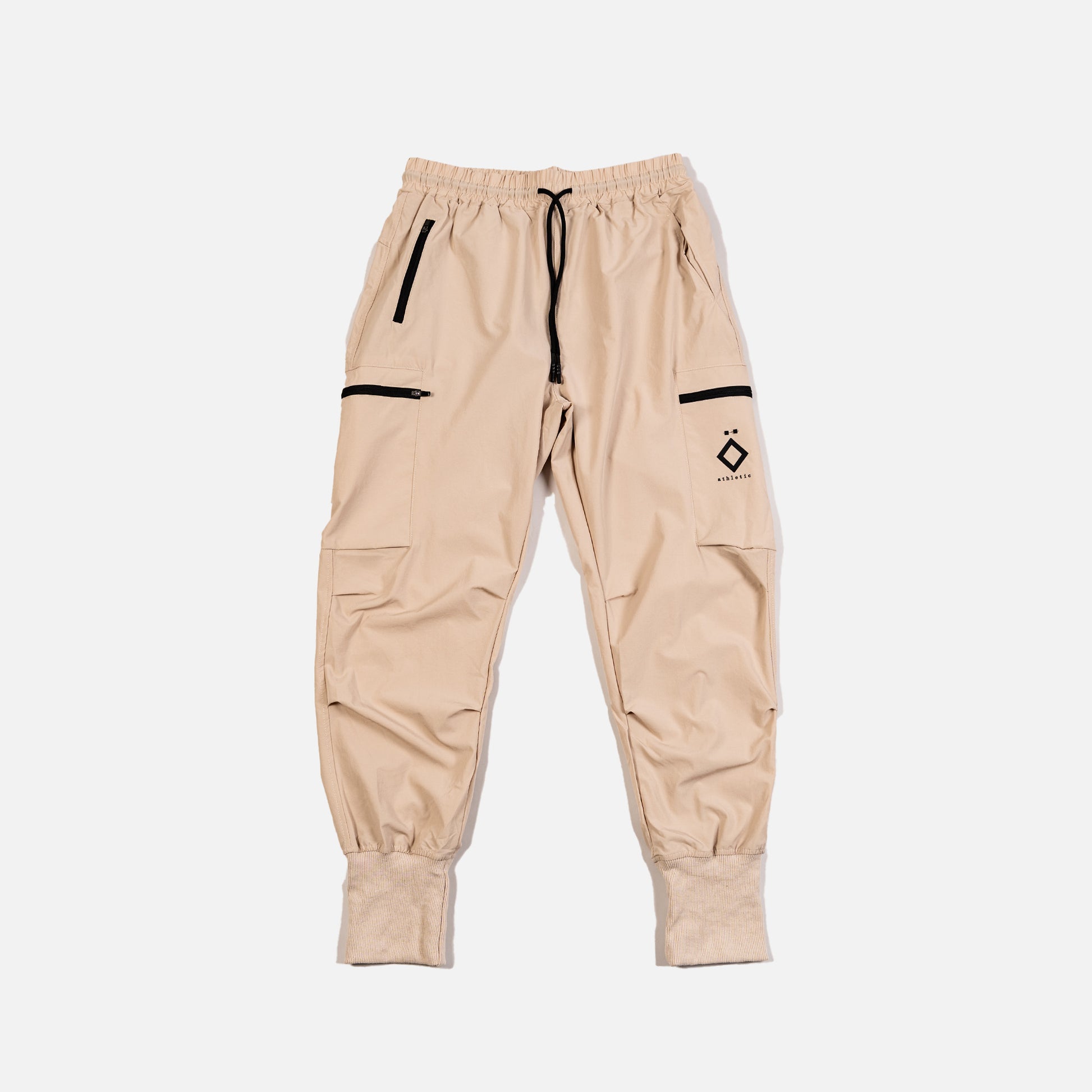 Beige jogger pants with black accents on a white background