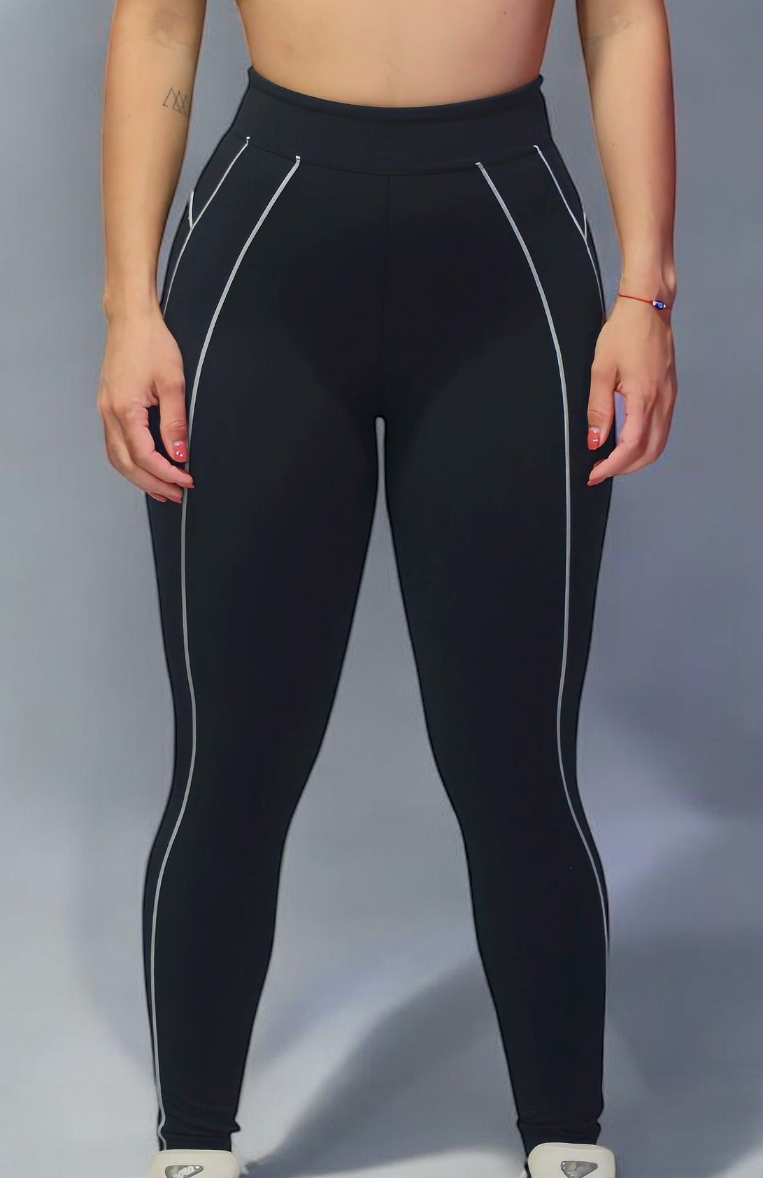 woman wearing a black sports bra with white lines